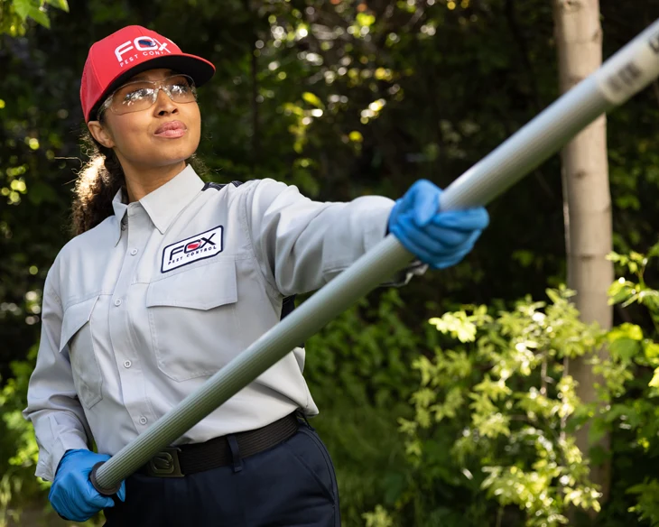 Pest control technician holding tool